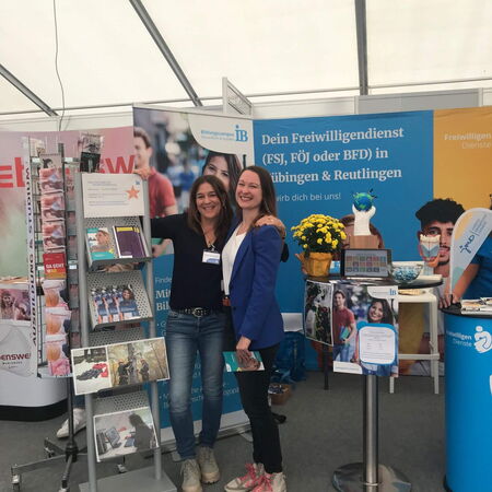 Zwei Frauen stehen lächelnd an einem Informationsstand über Freiwilligendienst in Tübingen und Reutlingen.